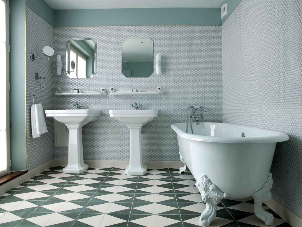Baignoire en fonte, robineterrie, carellage : atmosphère vintage dans les salles de bain