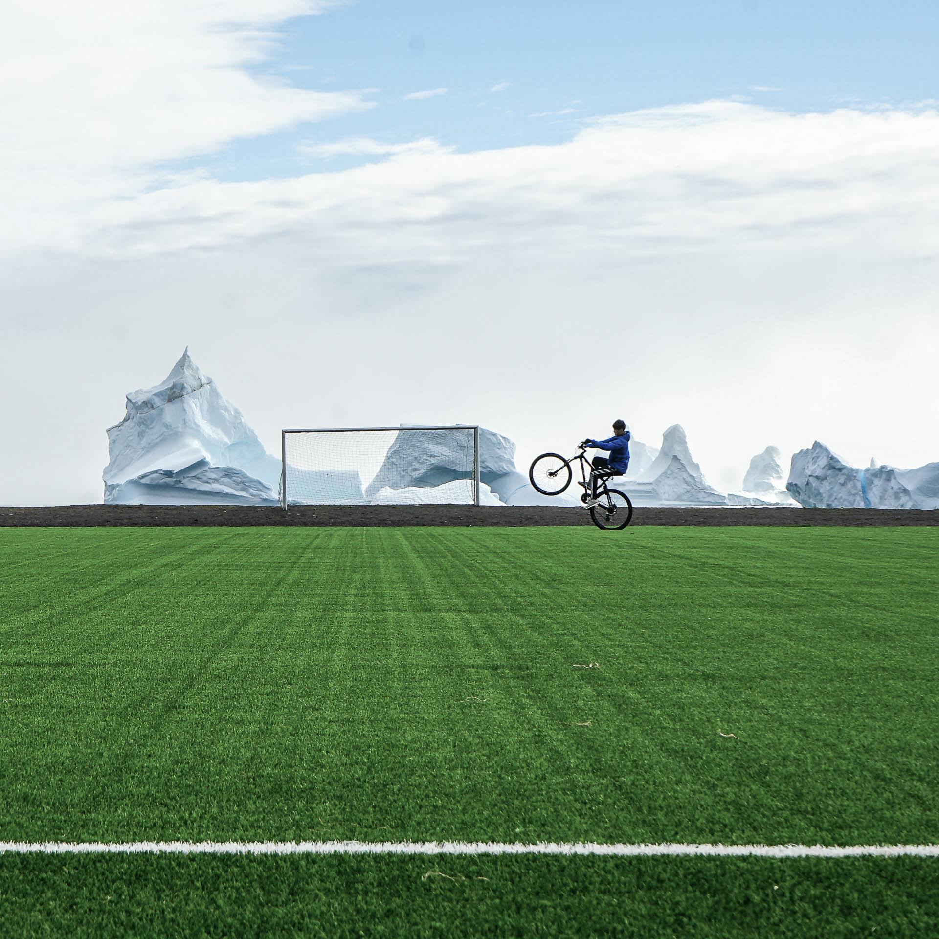 Un contraste irréel : vrais icebergs mais faux gazon... Terrain de football de Qeqertarsuaq sur l’île de Disko.© MB / Yonder