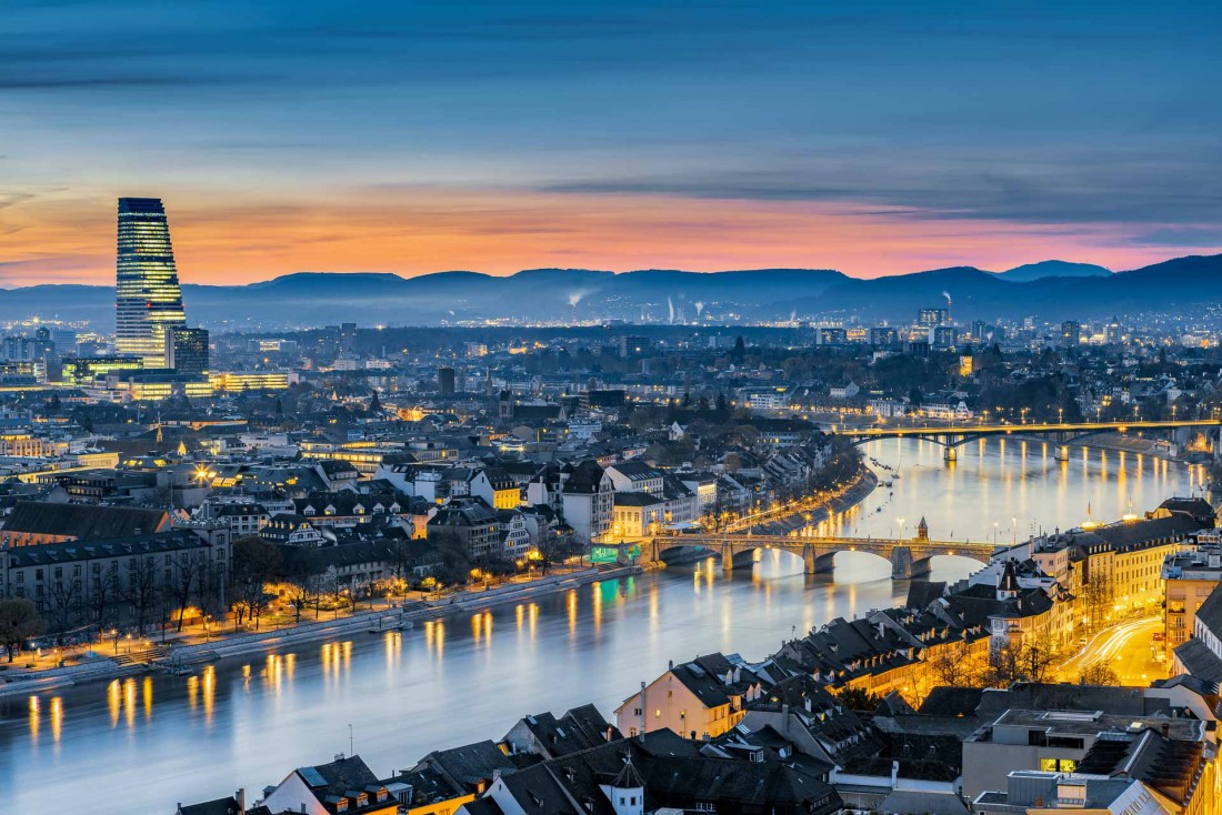 Vue spectaculaire sur le centre de Bâle et le Rhin, à la tombée de la nuit © Switzerland Tourism