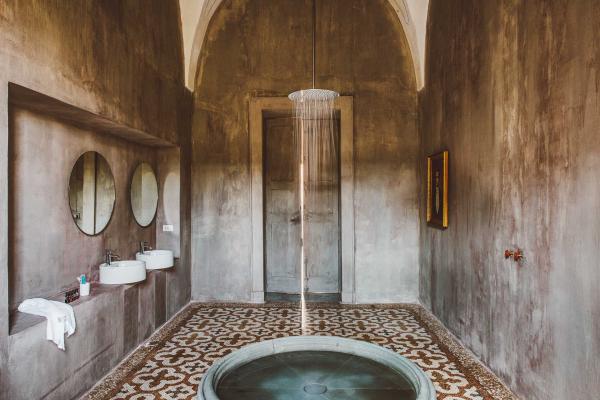 La salle de bain est une installation artistique, avec sa douche pluie de six mètres de hauteur, et bassin signé Andrea Sala.