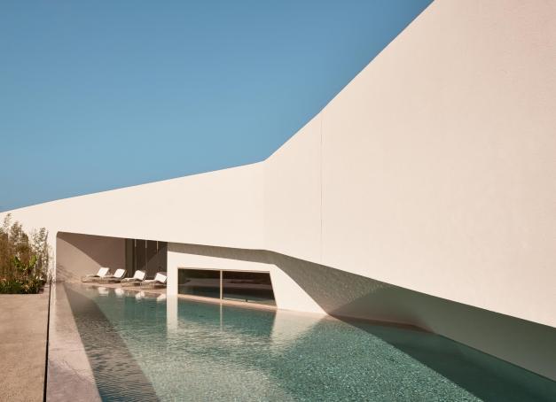 Dans un paysage inondé par la végétation, le NOŪS Santorini est une oasis dédiée au bien-être avec yoga, piscines privées, jacuzzis, jardins et espace de méditation.